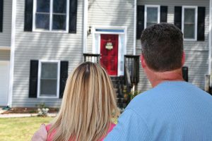 Home buyers looking at house for sale