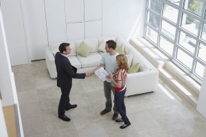 Couple meeting with real estate agent during home sale
