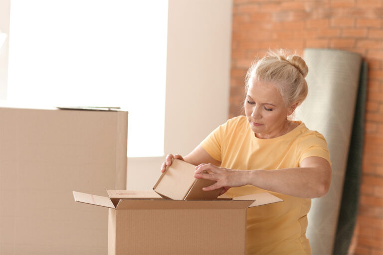 Divorced woman packing up for home sale