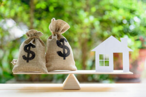 Balance of money and house, real estate market concept