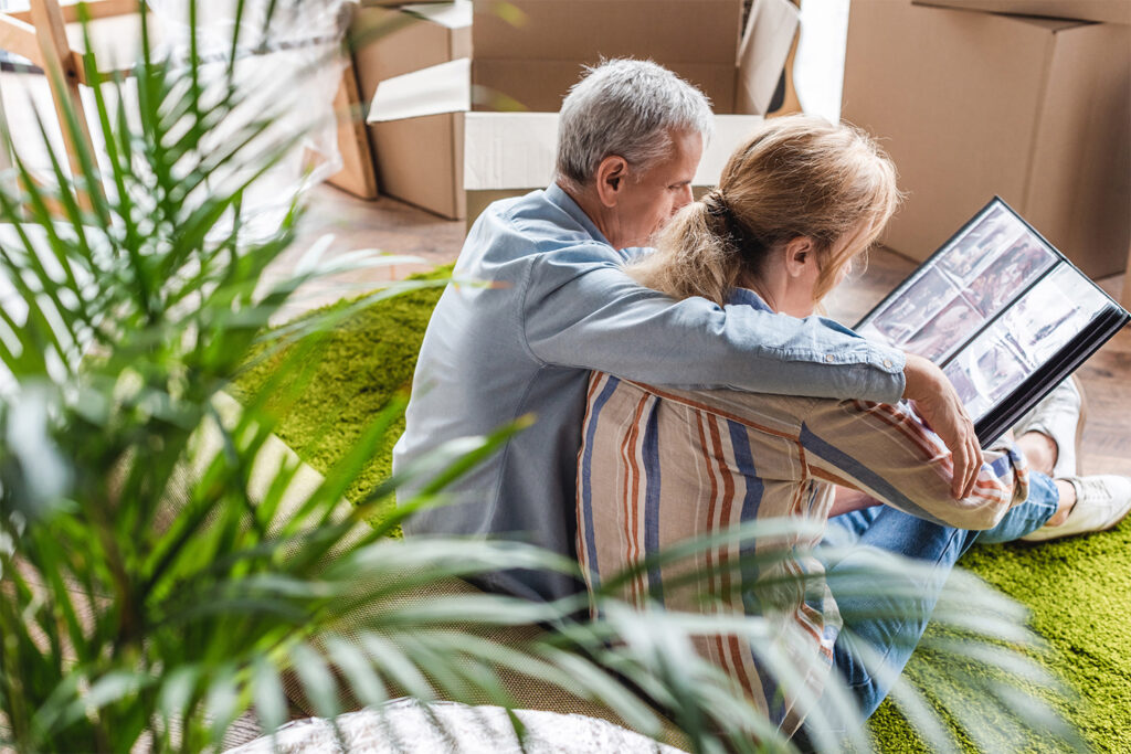 daughter sitting with elderly dad while moving, elderly parents move concept