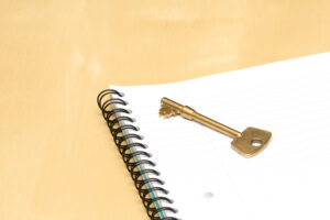 Key on a notebook, representing real estate documents