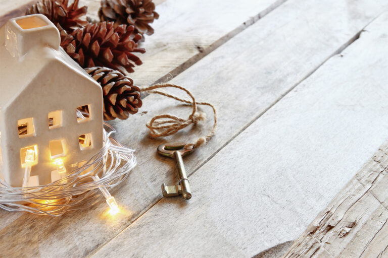 Holiday house and key, representing look ahead to 2024 real estate projections.