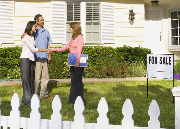 Realtor and clients, representing "best real estate agent" advertising.