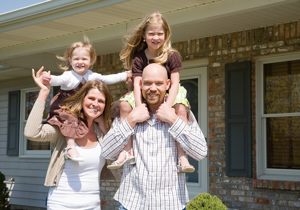 Family in front of house, representing planning a move with family.