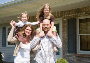 Family in front of house, representing planning a move with family.