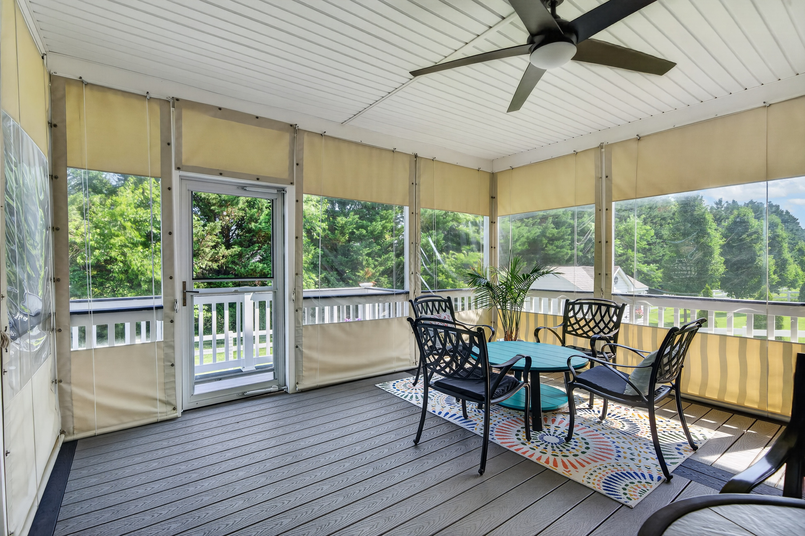 Screened rear deck at 151 Green Forest, set up for three-season evenings