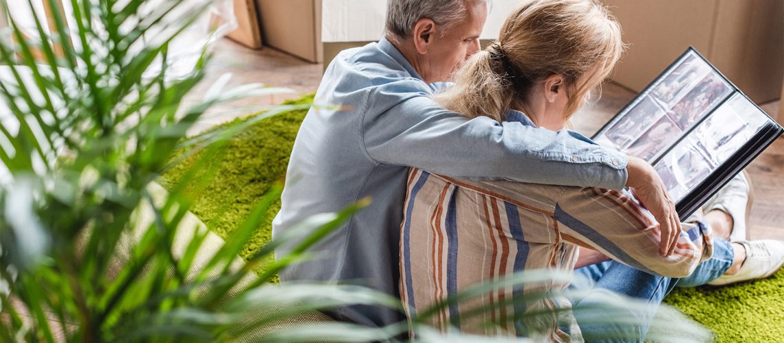 daughter sitting with elderly dad while moving, elderly parents move concept
