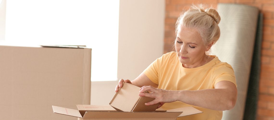 Divorced woman packing up for home sale