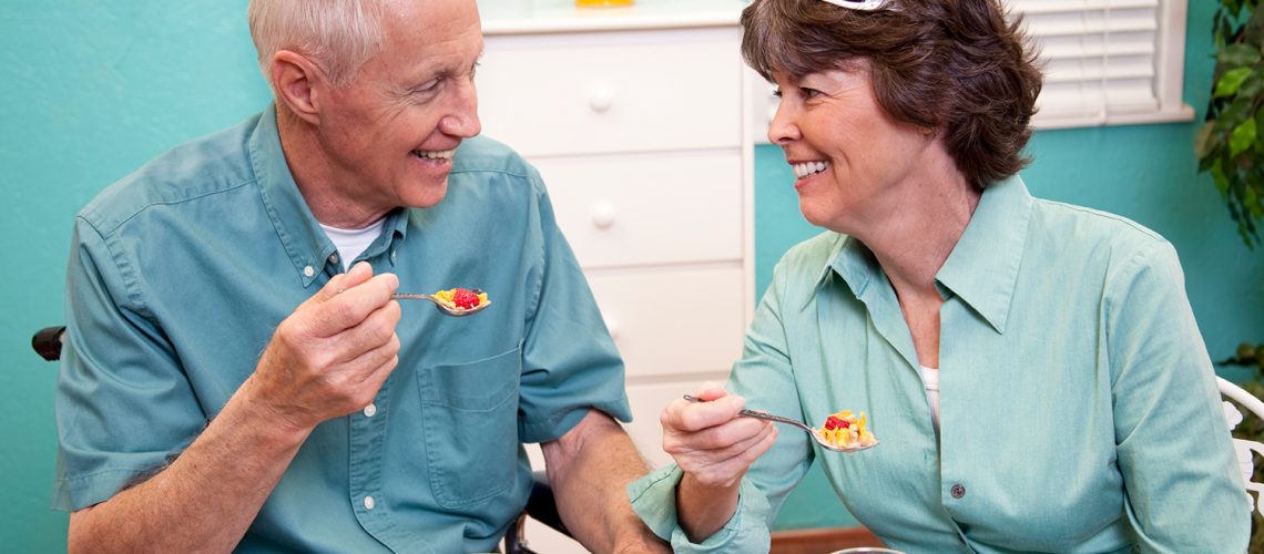 Older couple eating breakfast, representing senior housing trends